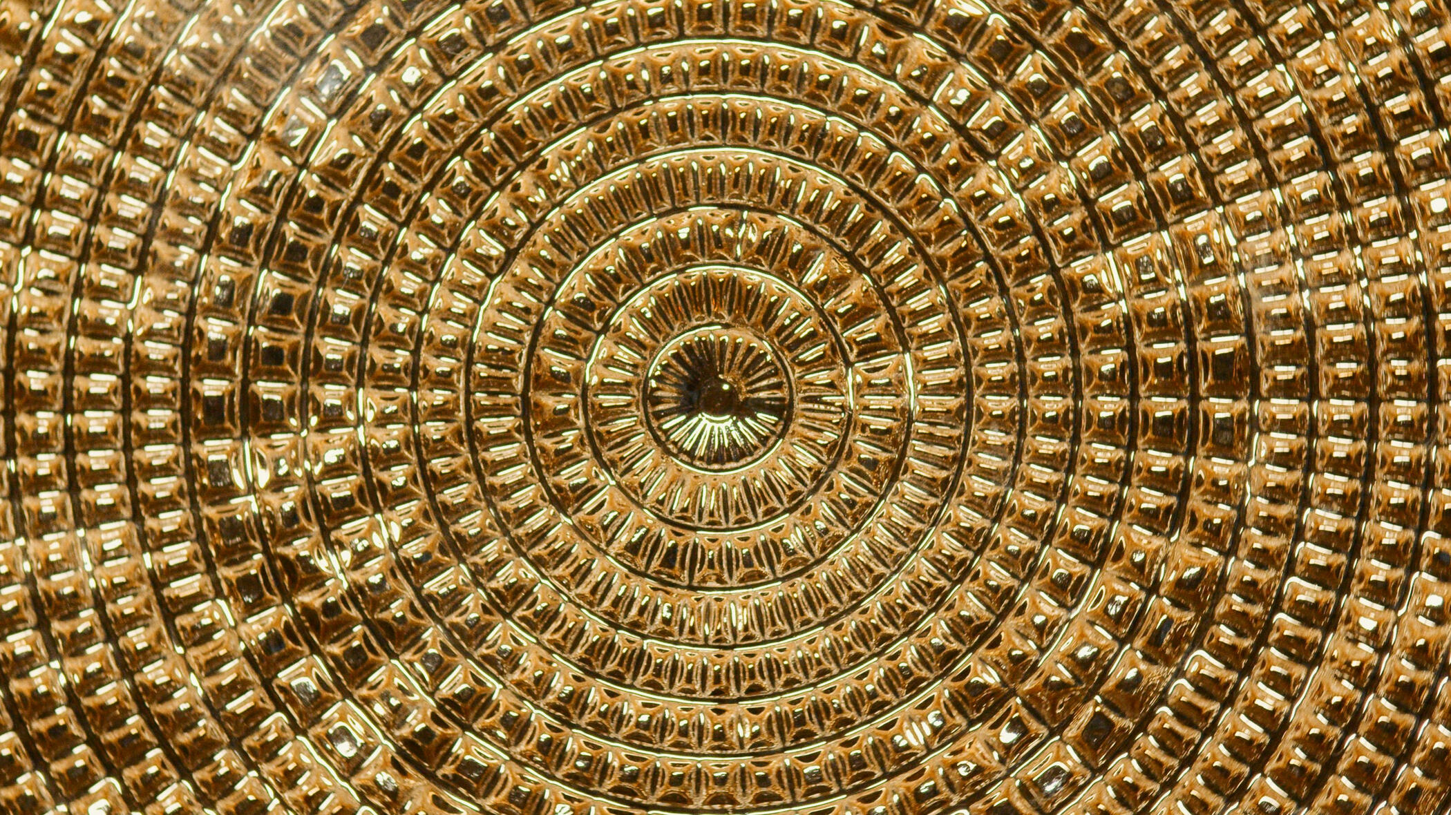 Abstract gold circular pattern representing unity, collaboration, and creative alignment.